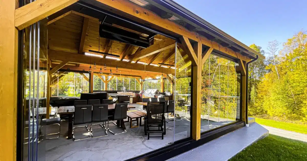 Novasun Panoramic glass panels stacked open around a timber-framed patio